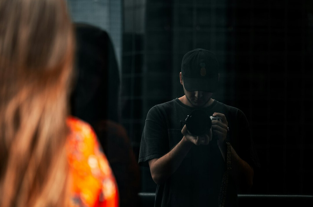 Man rehearsing a speech gesture in front of a mirror